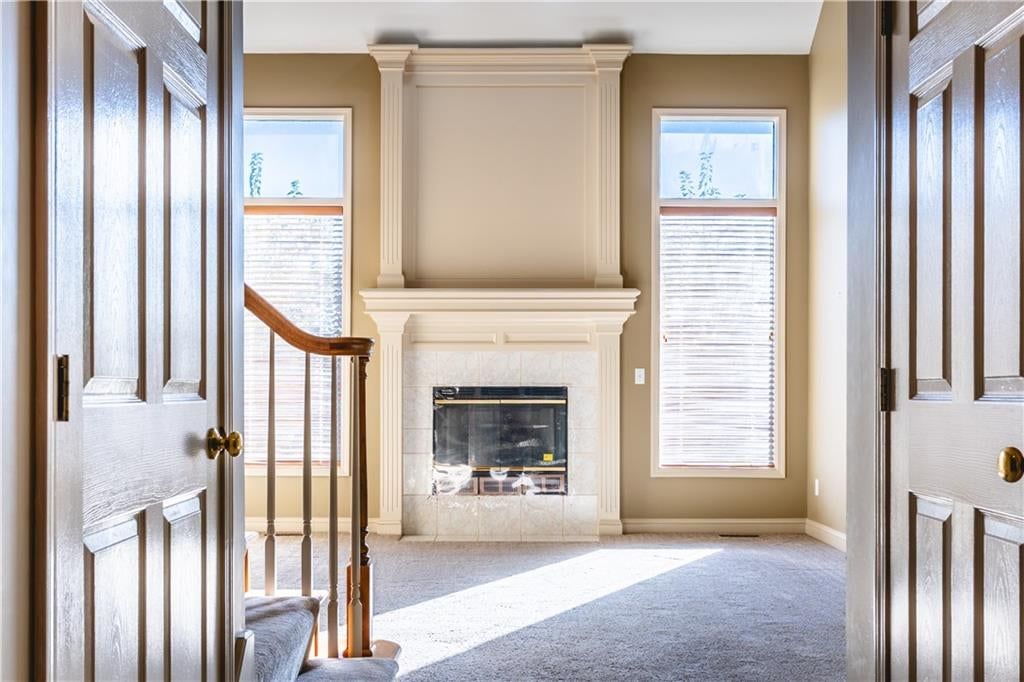 Fireplace, staircase and wood stair railing at 3725 SW Evergreen Lane, Lee's Summit, MO 64082