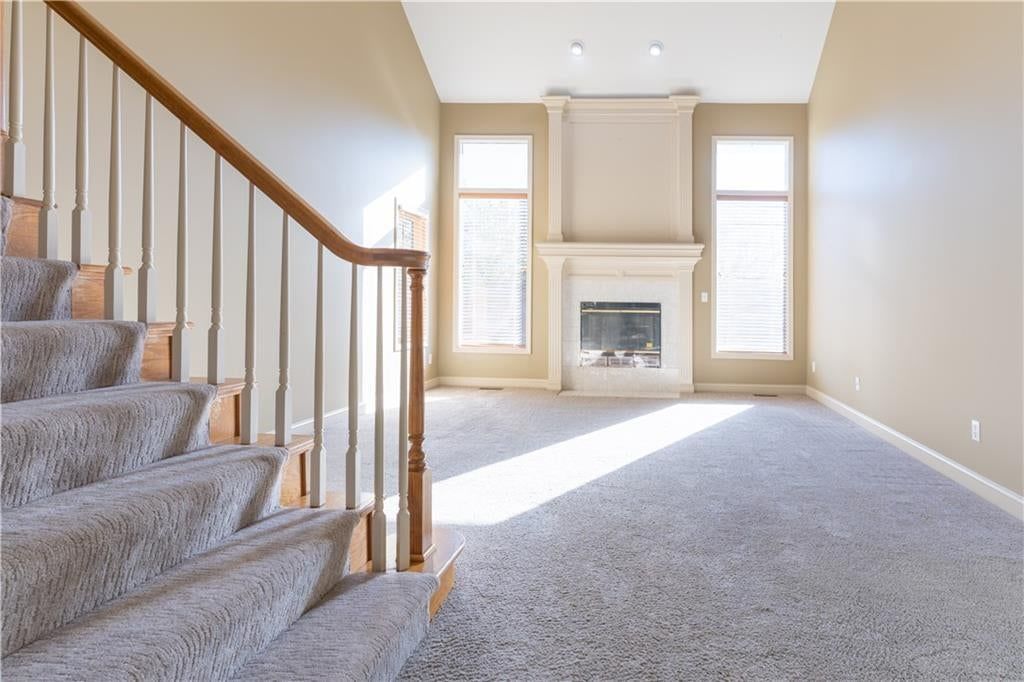 Tall ceilings, wall of windows and two-story living room at 3725 SW Evergreen Lane, Lee's Summit, MO 64082