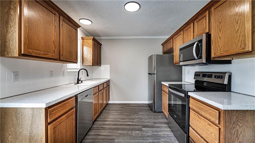 Stainless steel appliances, wood kitchen cabinets and electric range at 11200 N Central Street, Kansas City, MO 64155