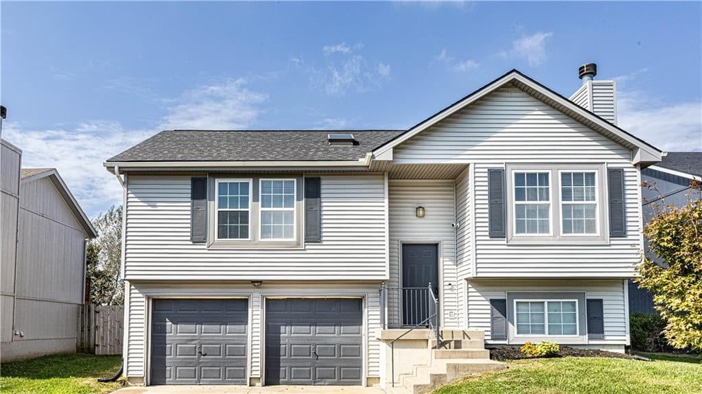 Attached garage, black roof and asphalt shingle roof at 11200 N Central Street, Kansas City, MO 64155