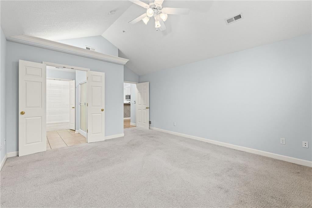 Main-floor primary bedroom and carpet at 7110 Hedge Lane Terrace, Shawnee, KS 66227