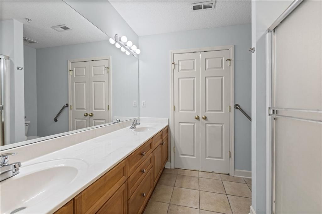 Double vanity and wood vanity at 7110 Hedge Lane Terrace, Shawnee, KS 66227