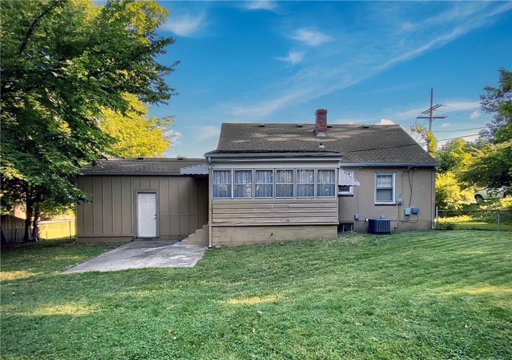 Fenced yard, chain-link fence and concrete patio at 1231 W 79th Street, Kansas City, MO 64114