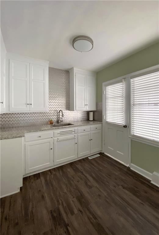 White kitchen, shaker cabinets and kitchen backsplash at 1231 W 79th Street, Kansas City, MO 64114