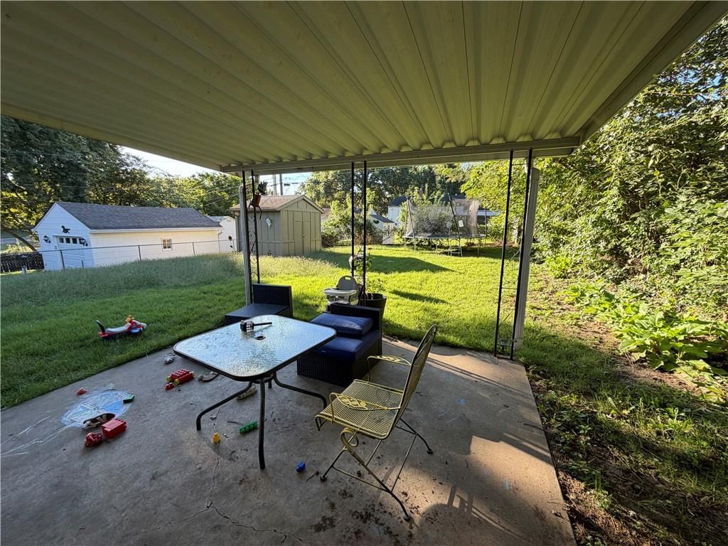 Covered patio, concrete patio and flat lot at 10501 E 27th Terrace S, Independence, MO 64052