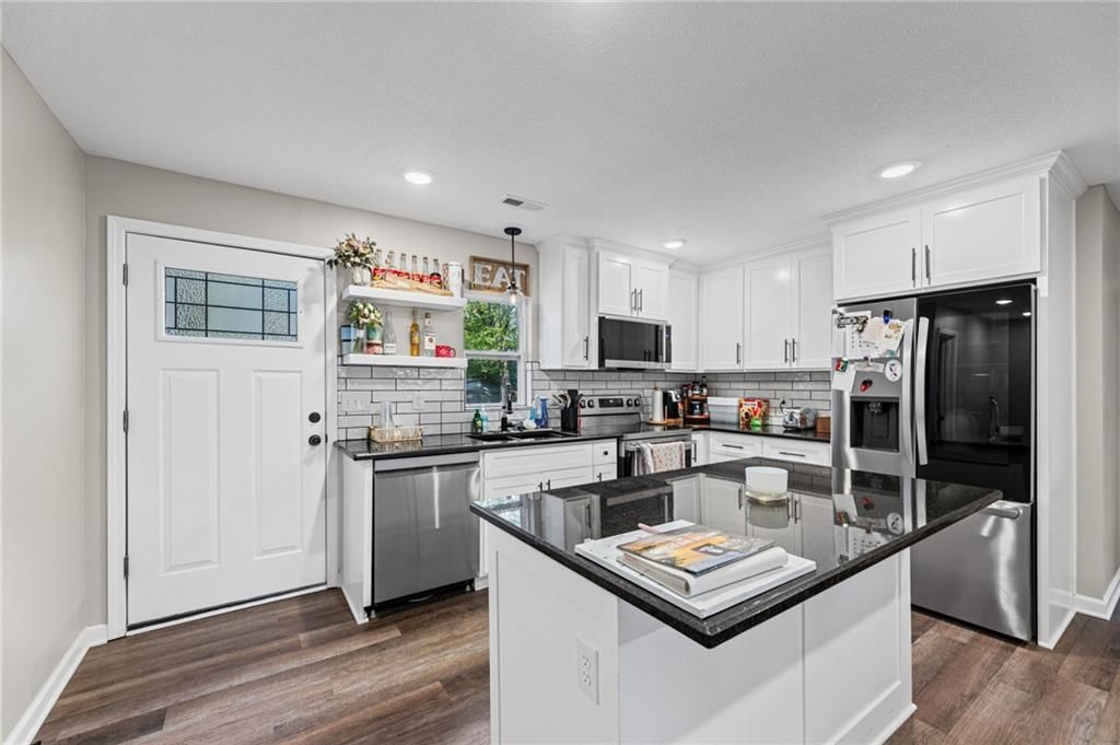 White kitchen, stainless steel appliances and updated kitchen at 1734 Main Street, Osawatomie, KS 66064