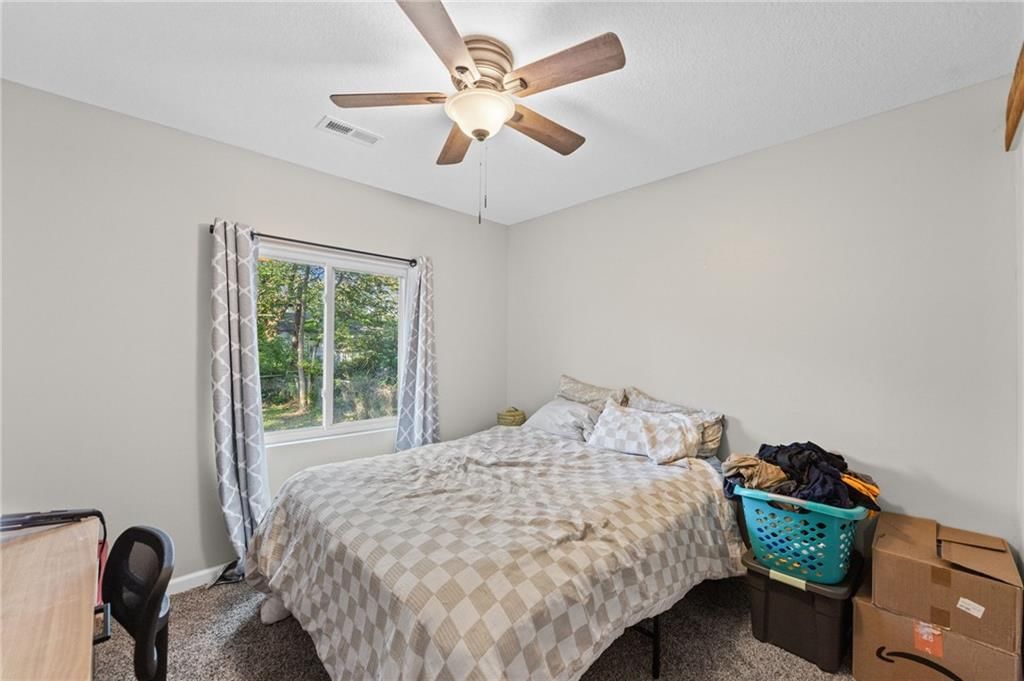 Main-floor primary bedroom and carpet at 1734 Main Street, Osawatomie, KS 66064