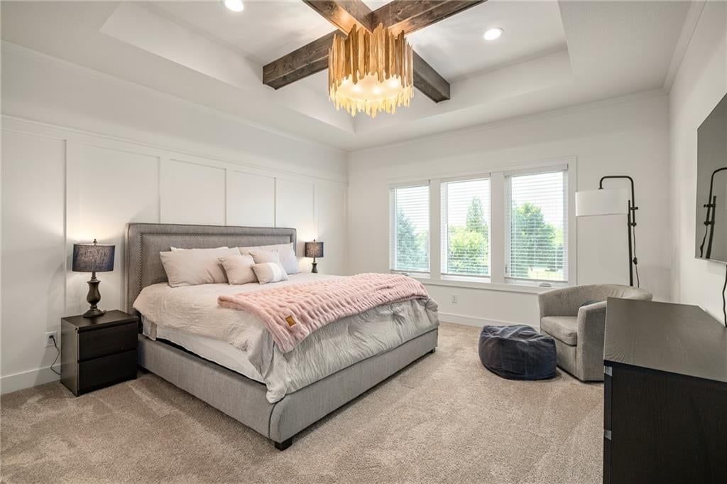 Main-floor primary bedroom, tray ceiling and ceiling beams at 4209 NE Hideaway Drive, Lee's Summit, MO 64064
