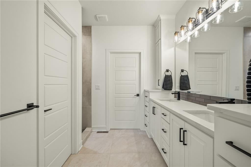 Double vanity, white vanity and renovated bathrooms at 4209 NE Hideaway Drive, Lee's Summit, MO 64064