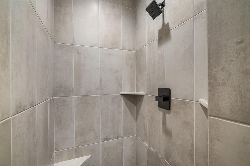 Walk-in shower and tiled shower at 4209 NE Hideaway Drive, Lee's Summit, MO 64064