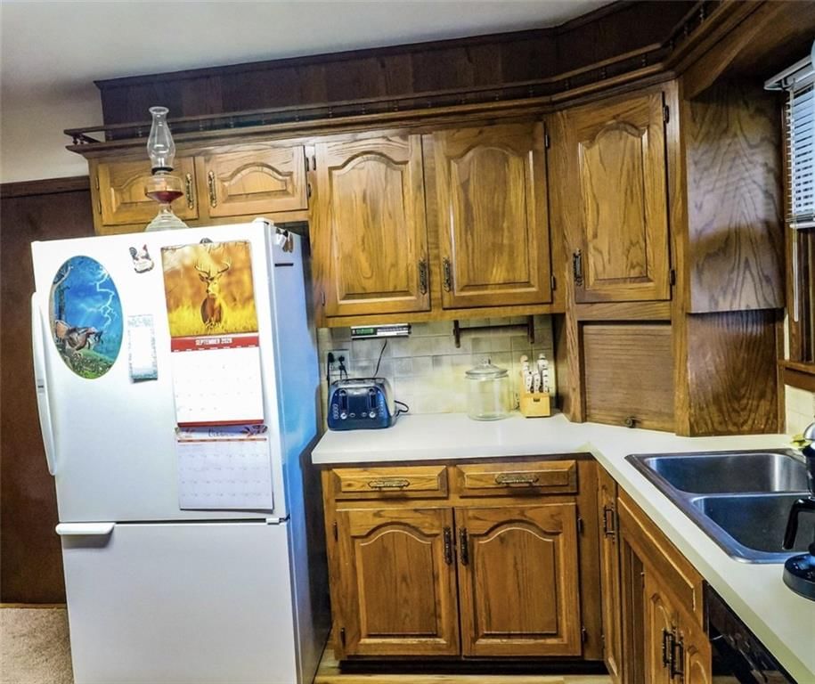 Wood kitchen cabinets, kitchen backsplash and raised-panel cabinets at 12612 East 48th Terrace, Independence, MO 64055