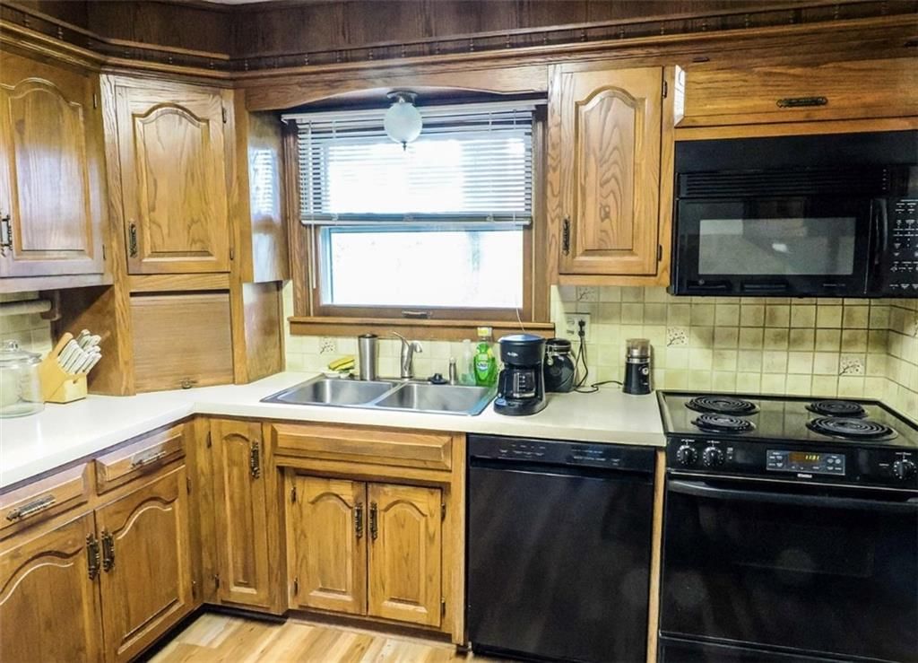 Electric range and mixed-finish appliances at 12612 East 48th Terrace, Independence, MO 64055