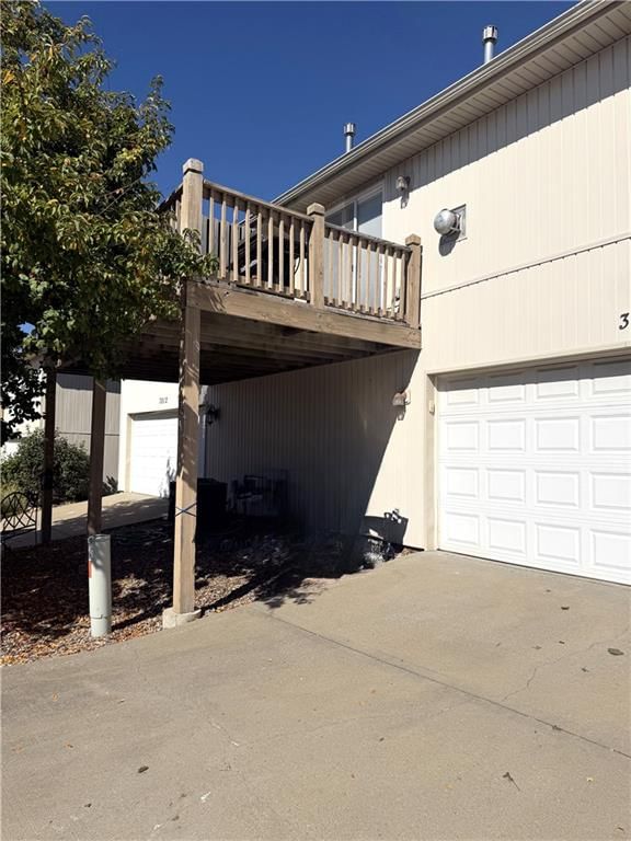 Deck, attached garage and concrete driveway at 3814 NE 86th Terrace, Kansas City, MO 64156