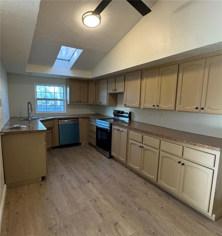 Electric range, mixed-finish appliances and beige or brown countertops at 8409 Curly Lane, Freeman, MO 64746