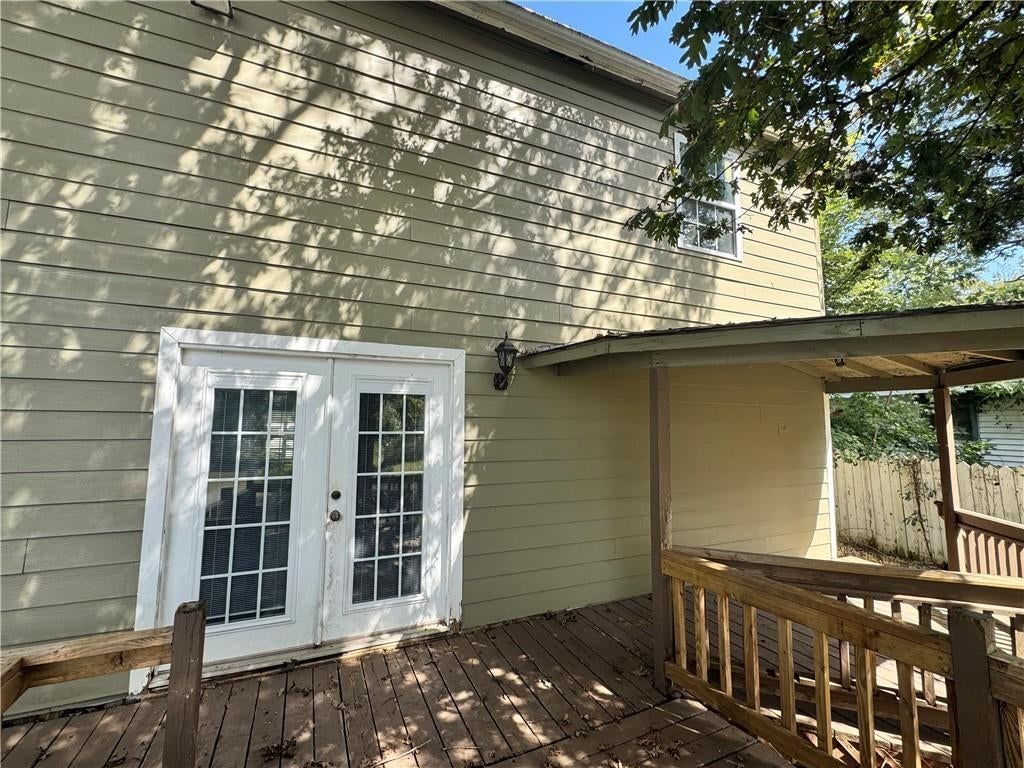 Deck, fenced yard and mature trees at 8409 Curly Lane, Freeman, MO 64746