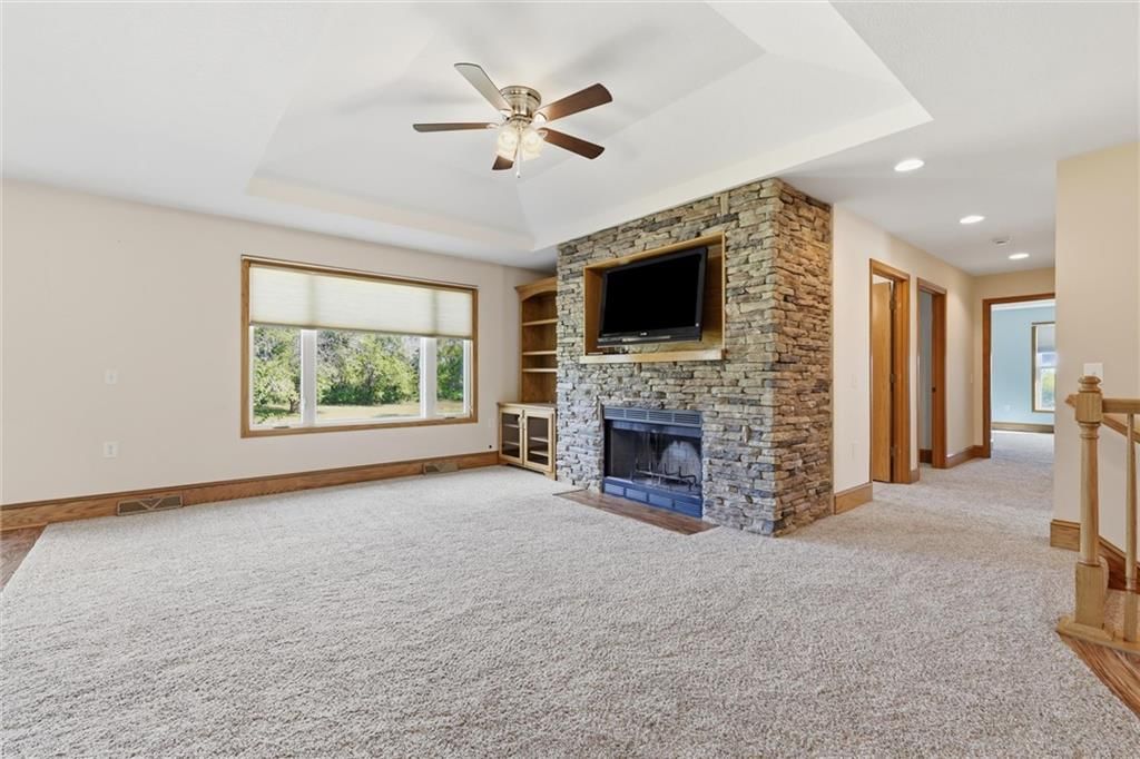 Fireplace, tray ceiling and wall of windows at 7000 Fort Myers Boulevard, Belton, MO 64012