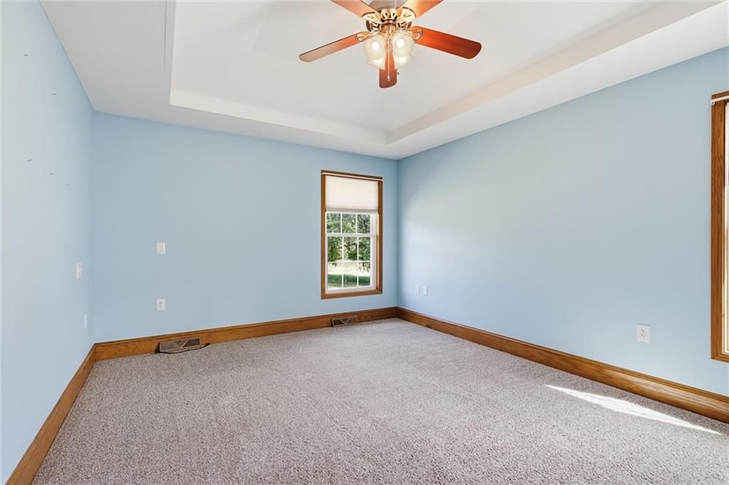 Main-floor primary bedroom at 7000 Fort Myers Boulevard, Belton, MO 64012
