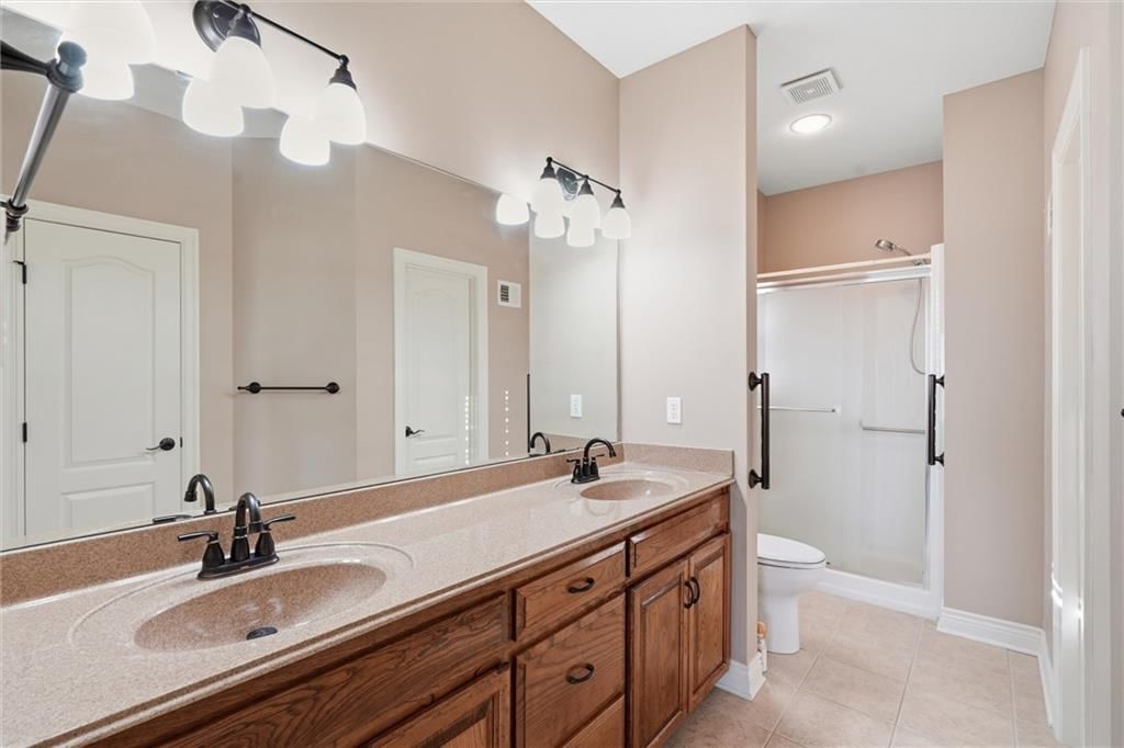 Walk-in shower and double vanity at 7600 NE 113th Street, Kansas City, MO 64157