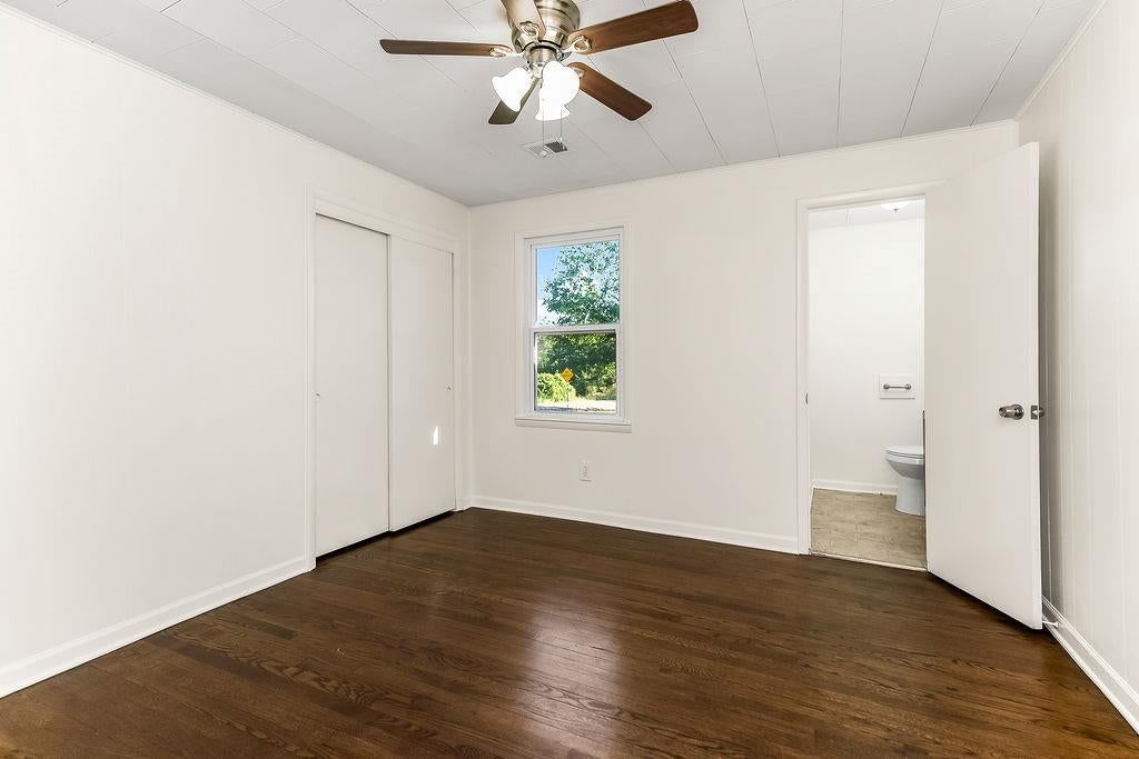 Main-floor primary bedroom and hardwood floors at 16000 Allen Avenue, Belton, MO 64012