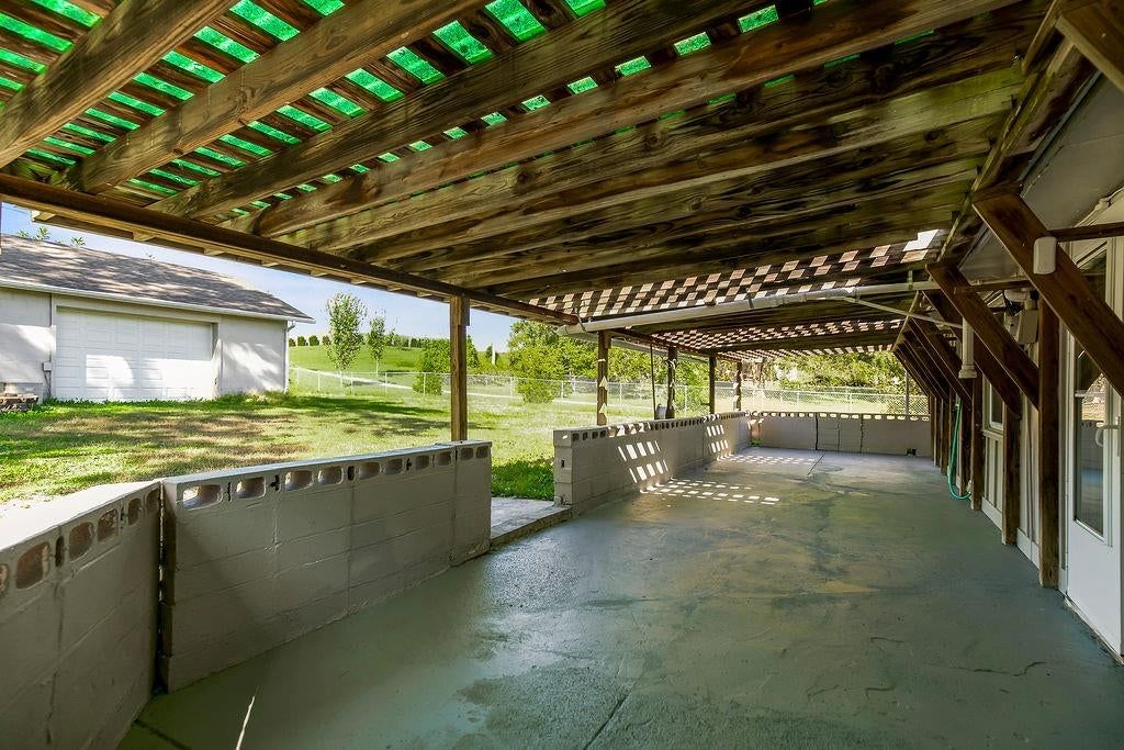 Covered patio and concrete patio at 16000 Allen Avenue, Belton, MO 64012
