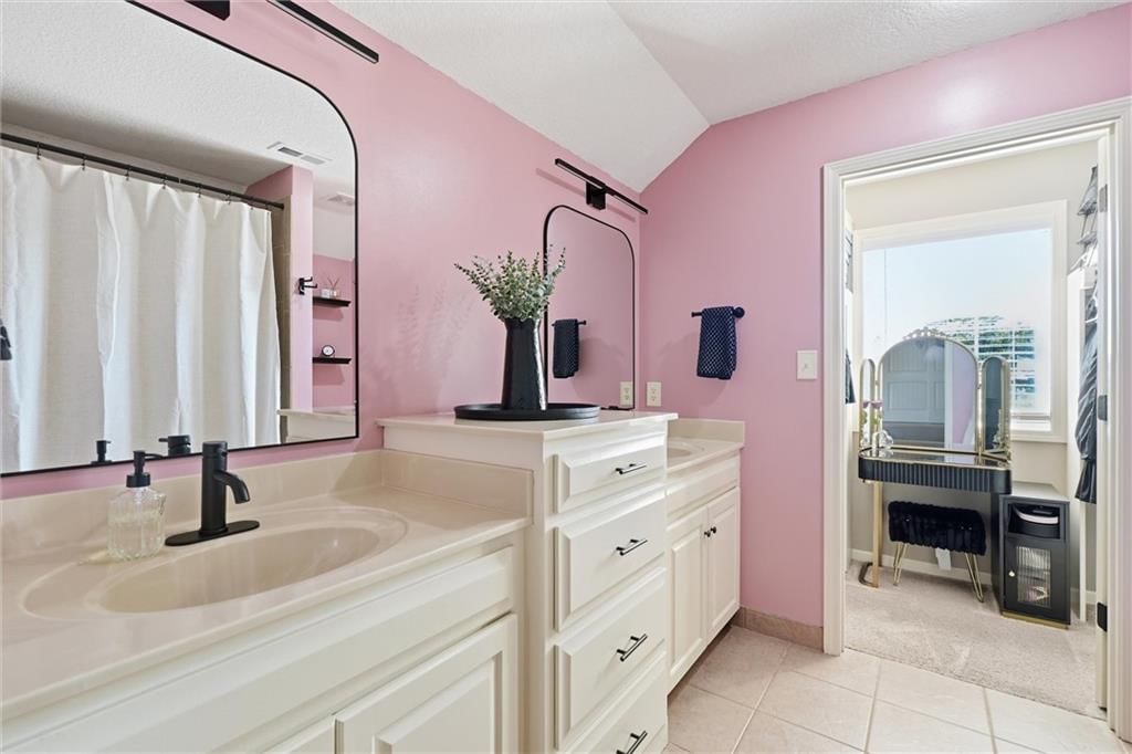 Tile floors, double vanity and white vanity at 16917 Cross Creek Drive, Belton, MO 64012