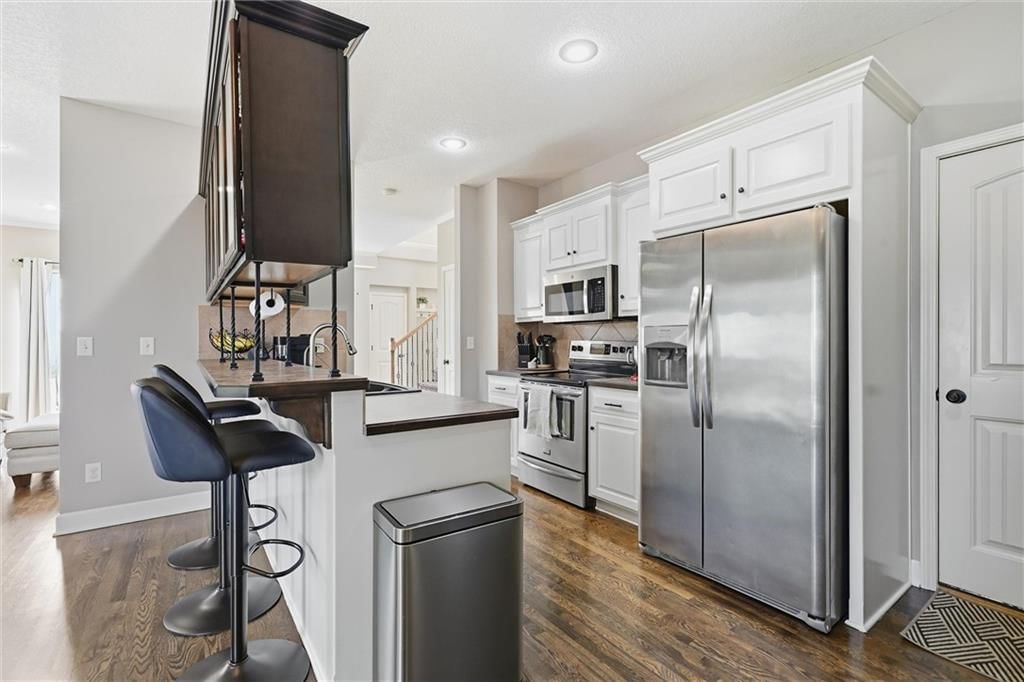 White kitchen, kitchen backsplash and subway tile backsplash at 16917 Cross Creek Drive, Belton, MO 64012