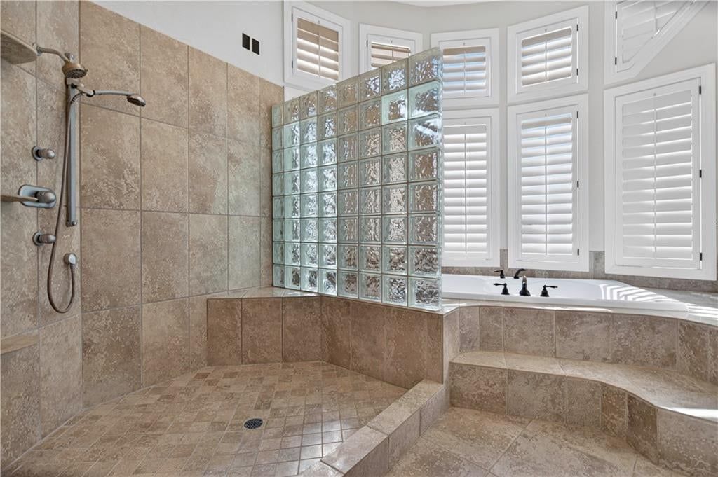 Walk-in shower and tiled shower at 118 NE Edgewater Drive, Lee's Summit, MO 64064