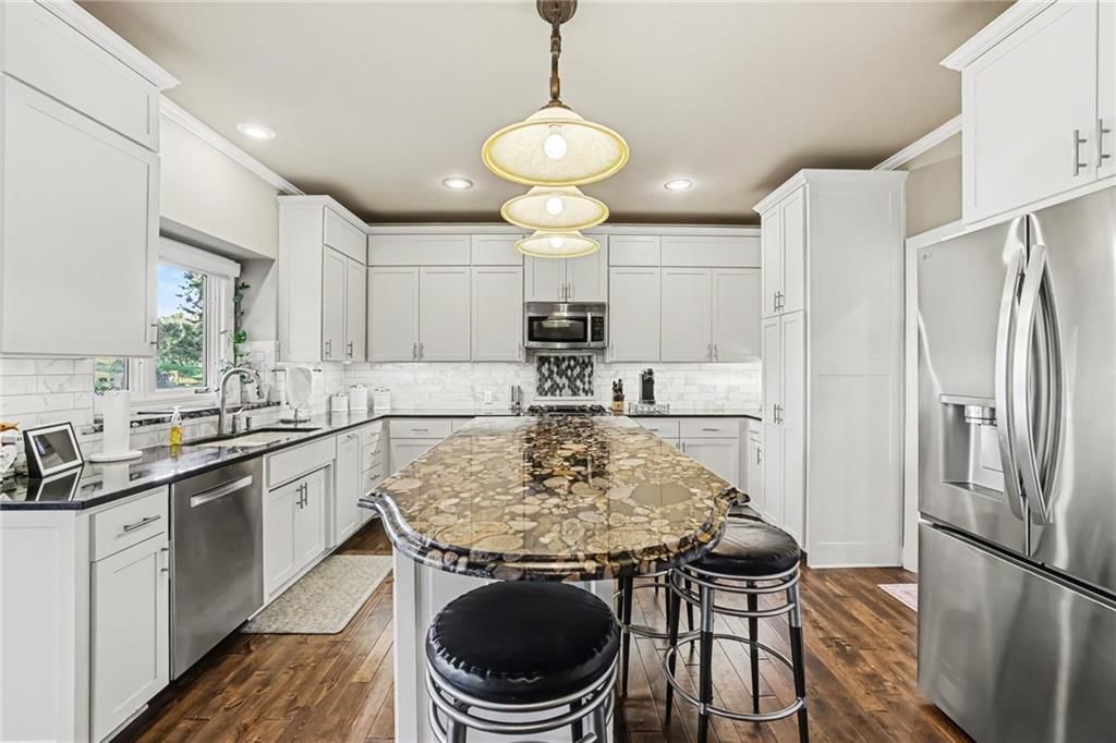 Kitchen island, white kitchen and shaker cabinets at 14104 Kessler Street, Overland Park, KS 66221