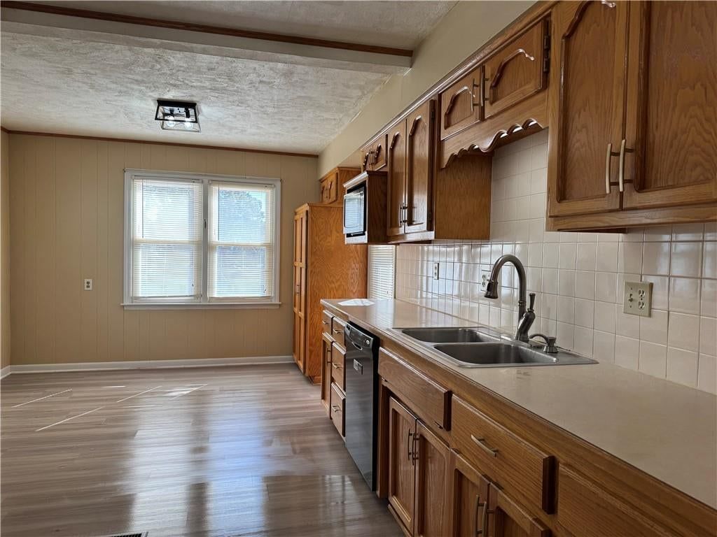Shiplap / paneling, breakfast nook and wood kitchen cabinets at 1401 NE 67th Terrace, Gladstone, MO 64118
