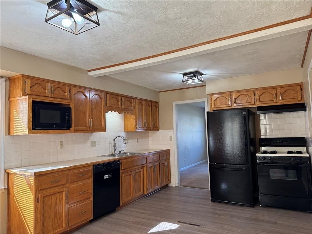 Gas range and black appliances at 1401 NE 67th Terrace, Gladstone, MO 64118