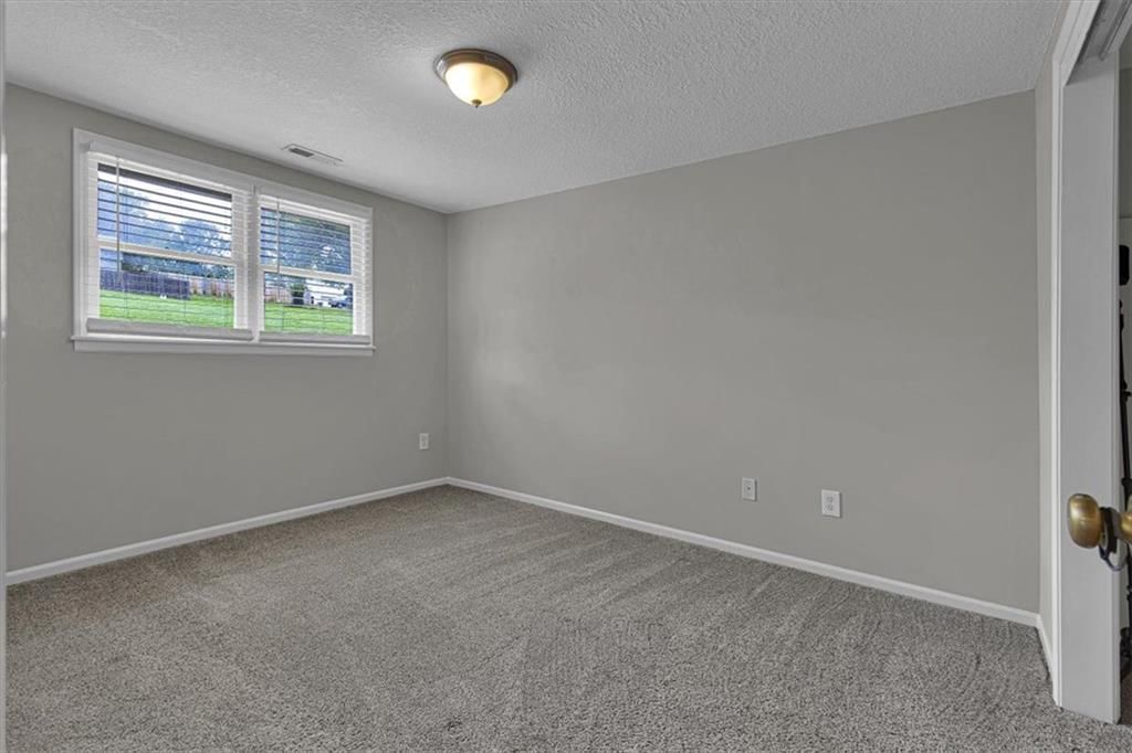 Main-floor primary bedroom at 6503 River Road, Pleasant Valley, MO 64068