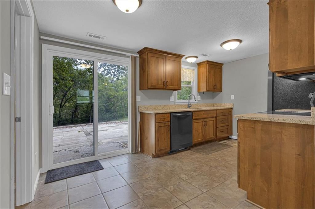 Shaker cabinets, wood kitchen cabinets and beige or brown countertops at 6503 River Road, Pleasant Valley, MO 64068