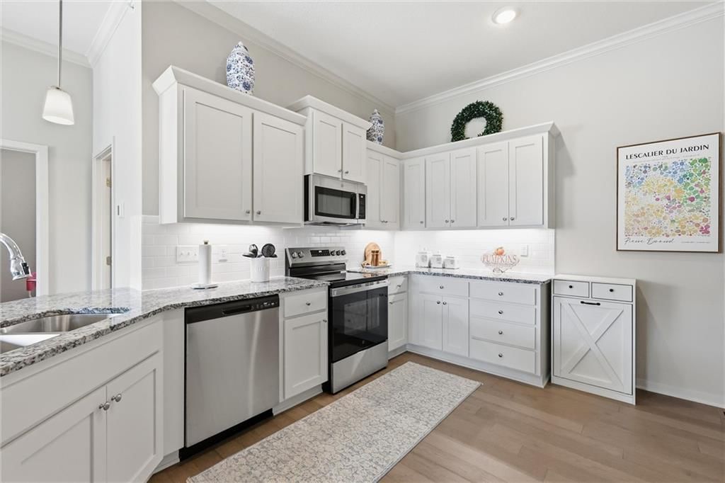 Kitchen island, white kitchen and granite counters at 21798 W 119th Terrace #1401, Olathe, KS 66061