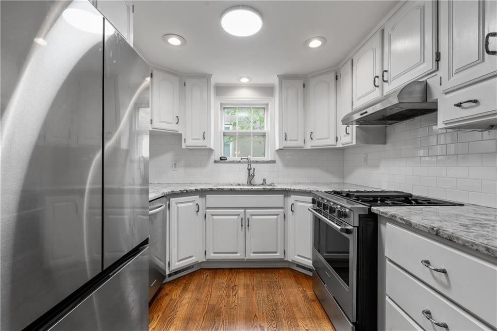 White kitchen, granite counters and stainless steel appliances at 5307 Aberdeen Road, Fairway, KS 66205