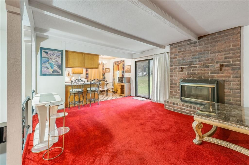 Fireplace, open floor plan and exposed brick wall at 1008 NW Arlington Court, Blue Springs, MO 64015