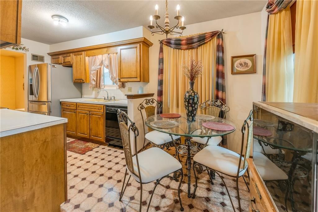 Wood kitchen cabinets and kitchen backsplash at 1008 NW Arlington Court, Blue Springs, MO 64015