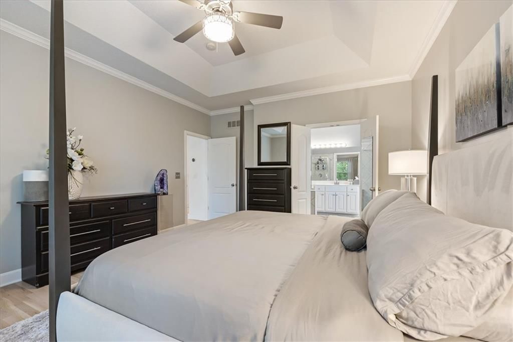 Main-floor primary bedroom and bedroom sitting area at 13725 Pembroke Circle, Leawood, KS 66224