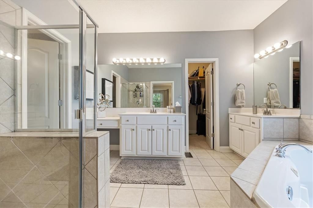 Walk-in shower, tiled shower and double vanity at 13725 Pembroke Circle, Leawood, KS 66224