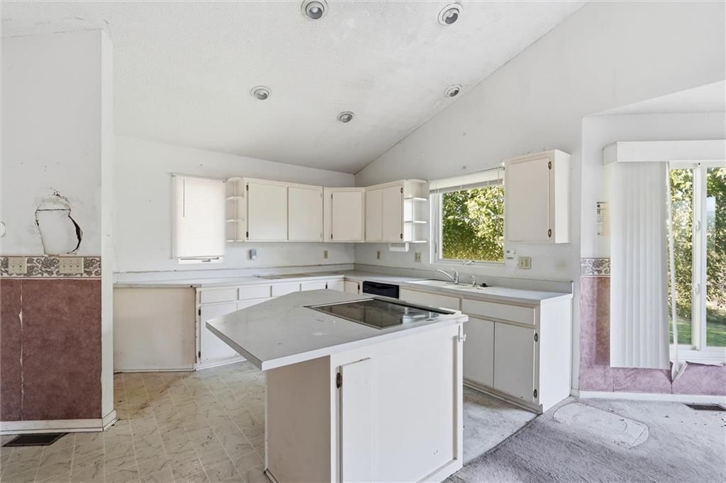 Kitchen island and white kitchen at 23900 E State Route EE Highway, Harrisonville, MO 64701