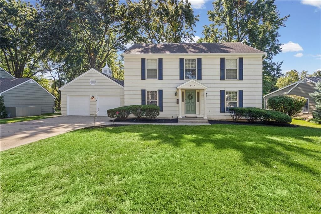 Covered front porch and mature trees at 5419 W 100th Terrace, Overland Park, KS 66207