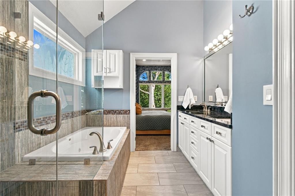 Walk-in shower and tiled shower at 624 W 131 Terrace, Kansas City, MO 64145