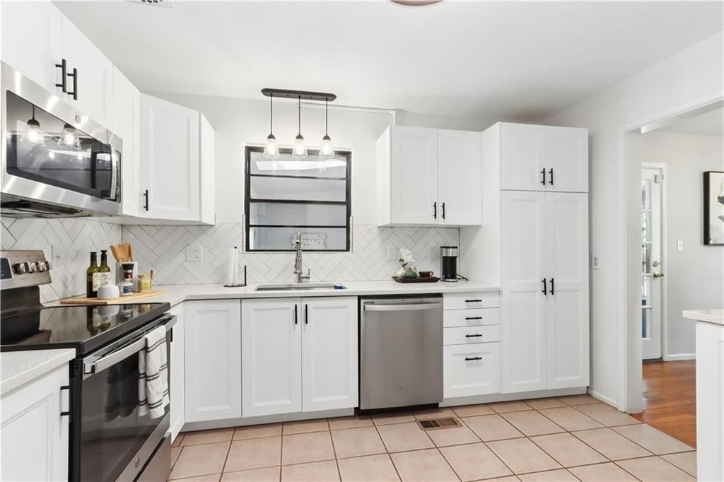 Photo 8: white kitchen cabinets, 7900 Pennsylvania Avenue, Kansas City, MO 64114