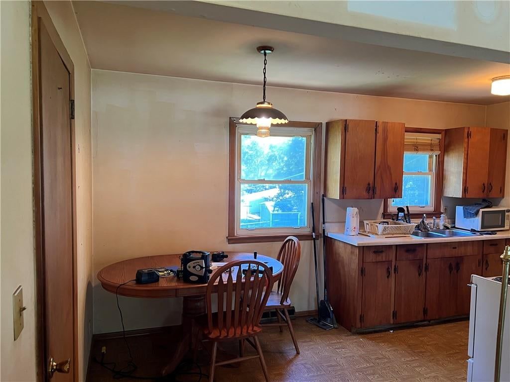 Breakfast nook and wood kitchen cabinets at 6001 N Michigan Place, Gladstone, MO 64118
