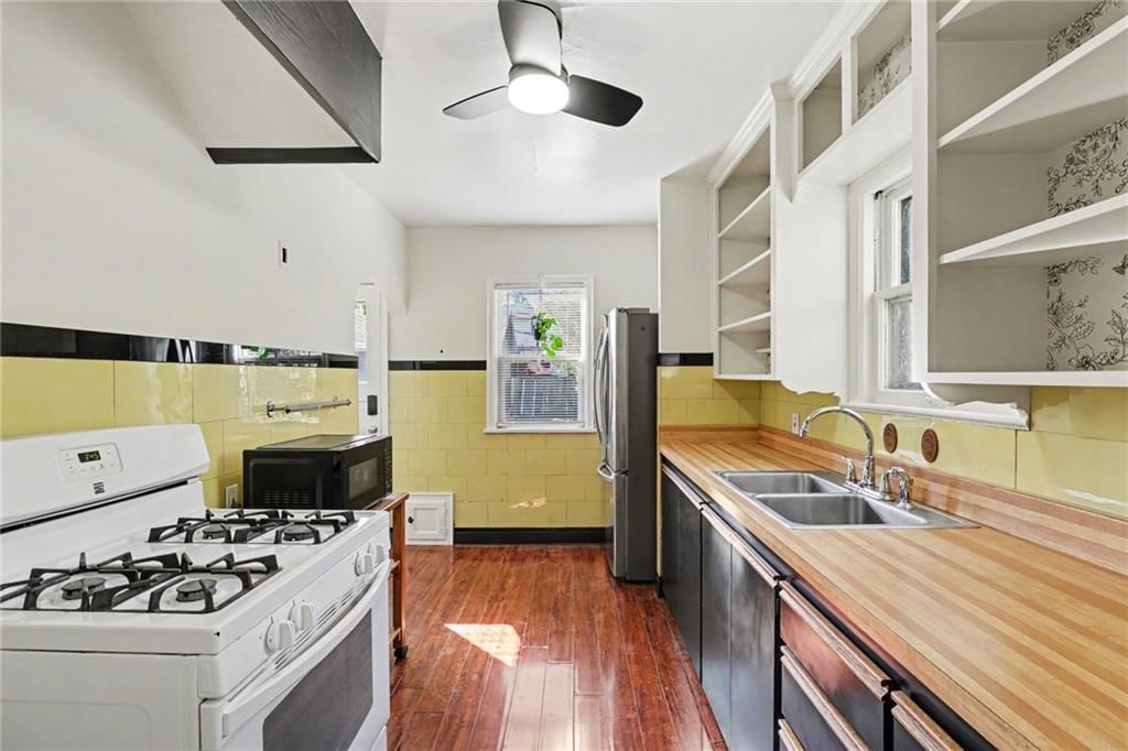 Butcher block countertops and black kitchen cabinets at 7346 GRAND Avenue, Kansas City, MO 64114