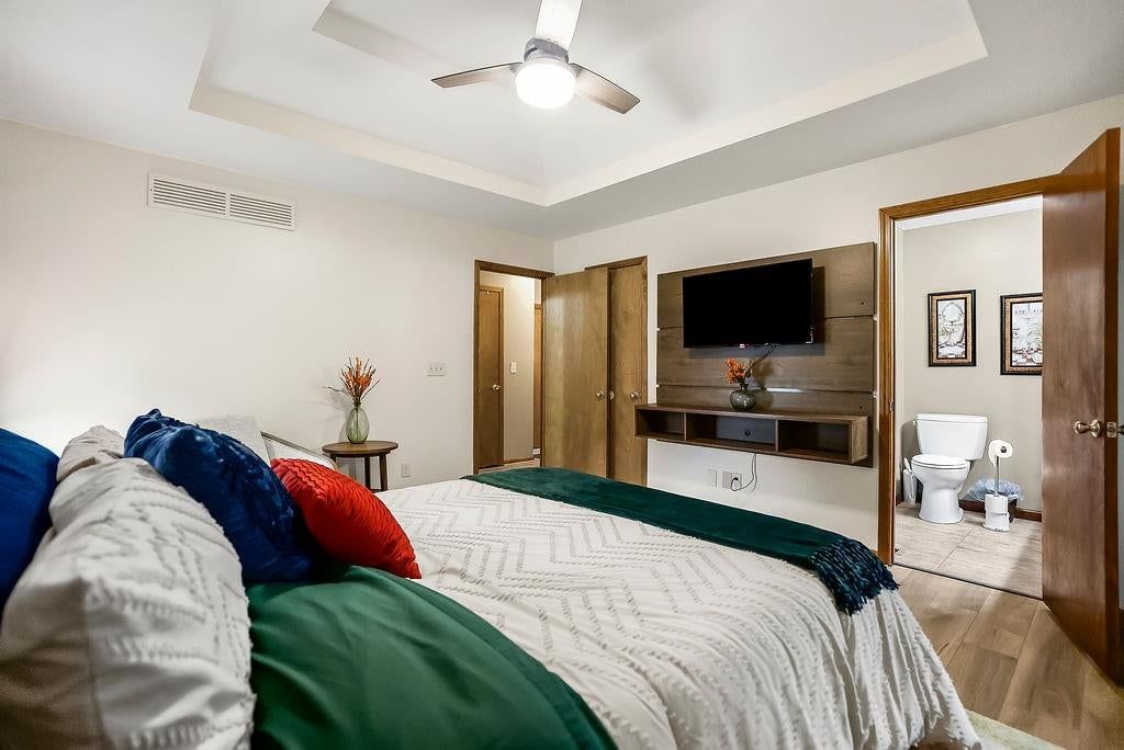 Main-floor primary bedroom and tray ceiling at 1107 ELM Circle, Pleasant Hill, MO 64080