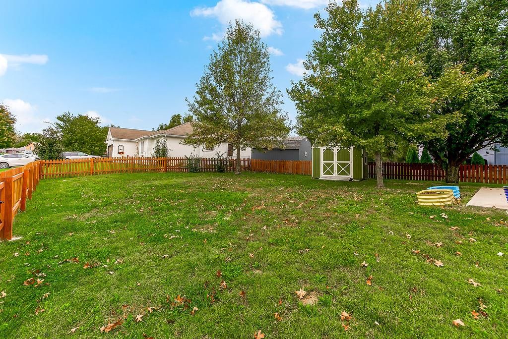 Big backyard, fenced yard and mature trees at 1107 ELM Circle, Pleasant Hill, MO 64080