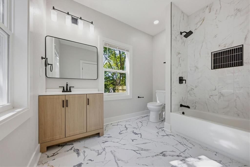 Tile floors and tiled shower at 3710 Agnes Avenue, Kansas City, MO 64128
