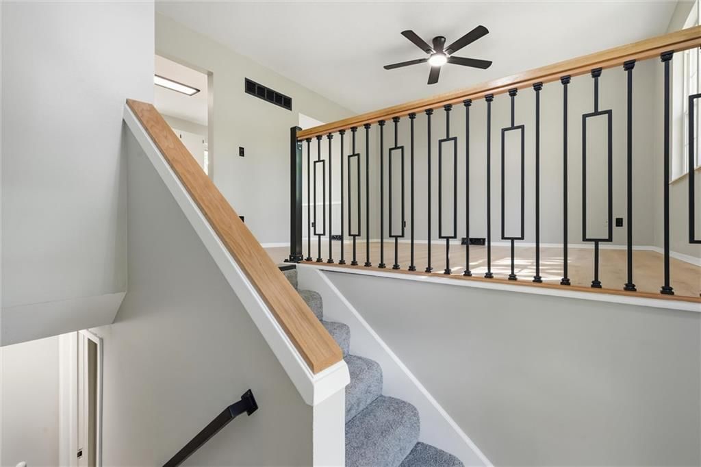 Staircase and iron stair railing at 205 SW Kingscross Road, Blue Springs, MO 64014