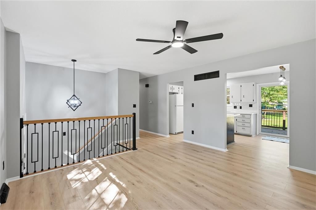 Statement lighting, white trim and gray walls at 205 SW Kingscross Road, Blue Springs, MO 64014