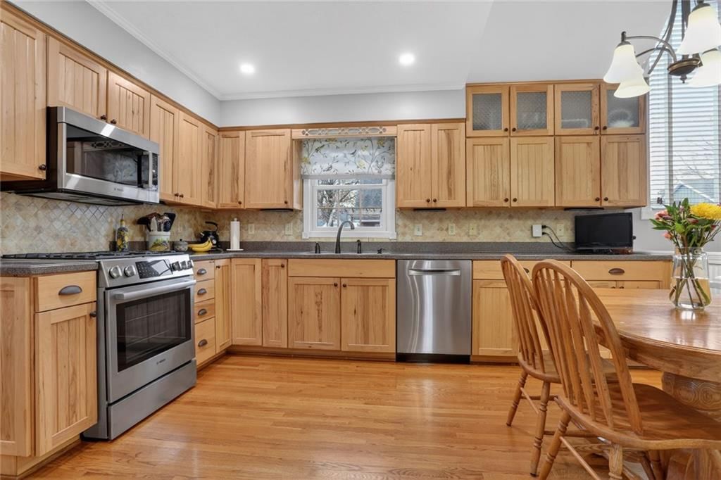 Hardwood floors, gas range and stainless steel appliances at 14813 W 83rd Terrace, Lenexa, KS 66215